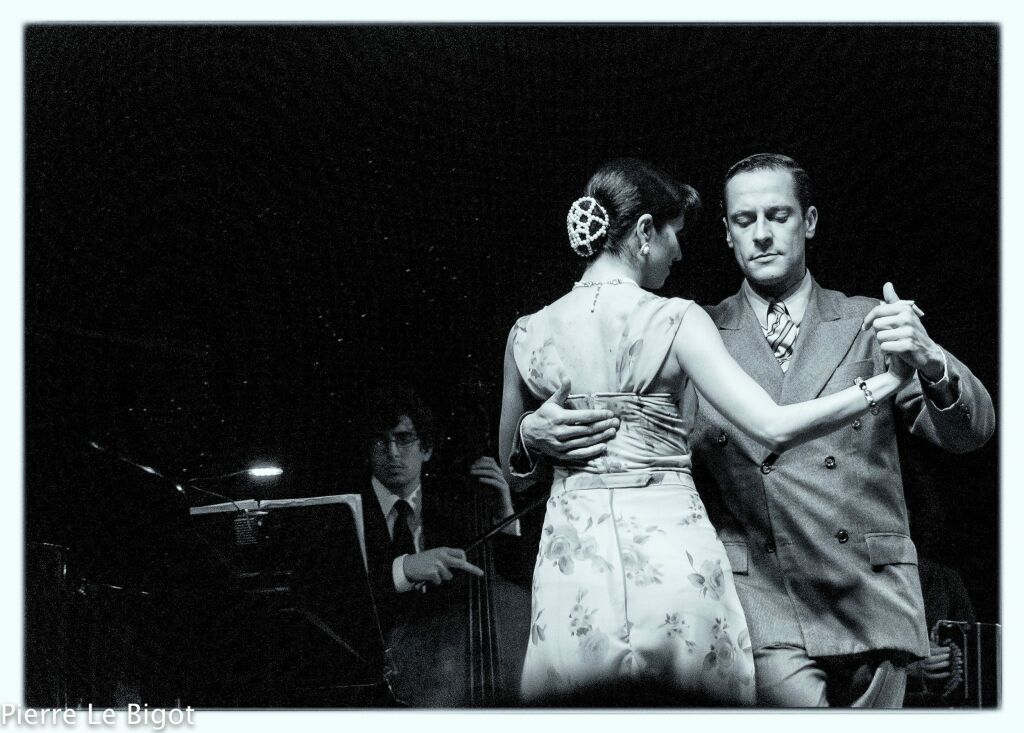 Black and white photo of man and woman waltzing