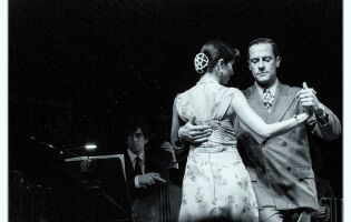 Black and white photo of man and woman waltzing