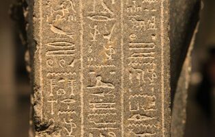 Ancient hieroglyphic markings on concrete slab