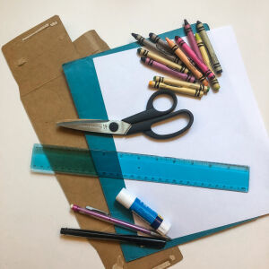 Paper, scissors, crayons, a glue stick, cardboard, a ruler, and pencils